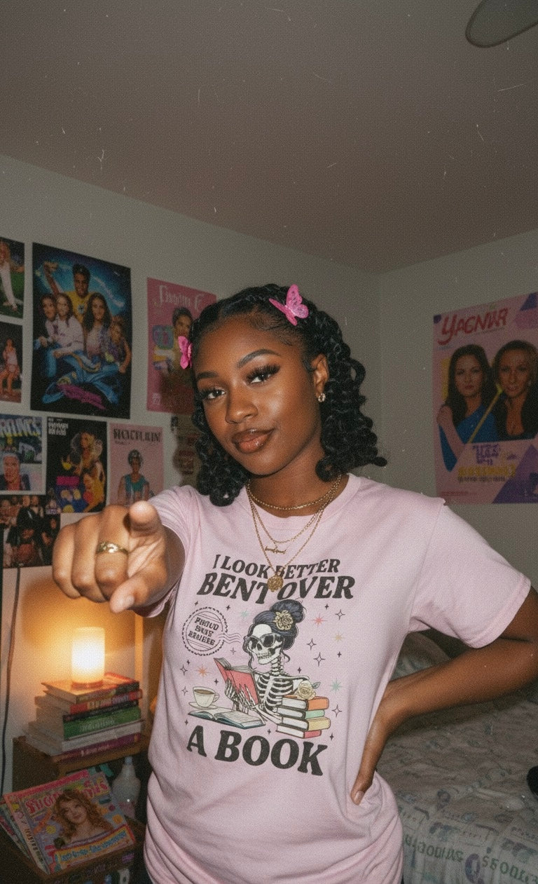 “Bent Over a Book” Skeleton Tee (Black Text)